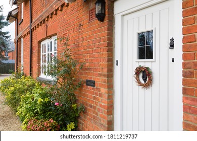 Front Of A Luxury Victorian Period House In England With Christmas Wreath On An Offwhite Wooden Door