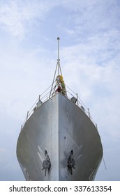 Front Of Modern Warship With Blue Cloudy Sky. Worm Eye View.