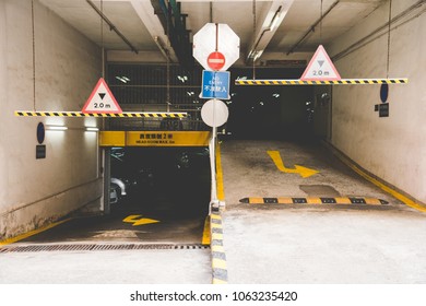 In Front Of Multi-level Car Parking Indoor In Apartment Buildings In Hong Kong. Entrance And Exit Way Car Parking Lot For Apartment In Asian Style.