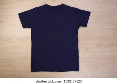 Front Navy Blue Tshirt On Wooden Background