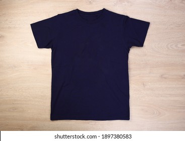 Front Navy Blue Tshirt On Wooden Background