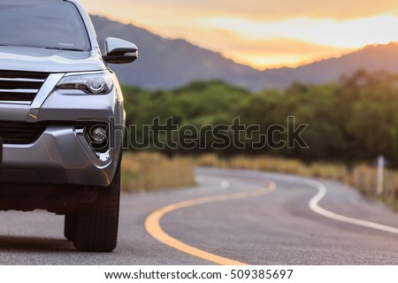 Front of new silver SUV car parking on the asphalt road