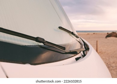 Front nose of motor home rv recreational vehicle camper van parked at the beach in free adventure travel vacation concept lifestyle. Sky and horizon in background. Road trip alternative parking - Powered by Shutterstock