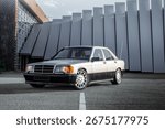 Front offset view of a German two tone zilver and black classic car with long antenna at a beautiful photo location