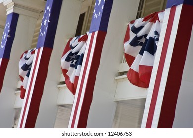 front of an old building with us flags and banners hanging from it