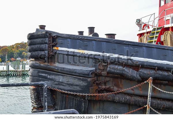 Front of an old tugboat at dock in Port Jefferson\
Harbor, New York.