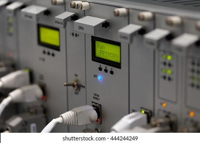 Front Panel Of Industrial Computer System With I/O Ethernet Connectors And Cables. Selective Focus On Primary CPU Module.