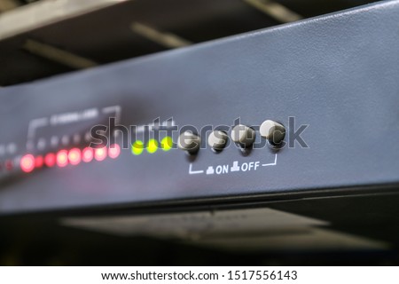 The front panel of the optical multiplexer is in the server room of the data center. Buttons to turn on and off are on the switching equipment. Selective focus.
