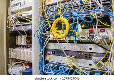 Front Panel Of The Telecommunications Box With Random Interweaving Of Wires.The Equipment Operates In The Data Center Cabinet.  Internet Communication Cables Are Connected To Telephony Ip Switches.