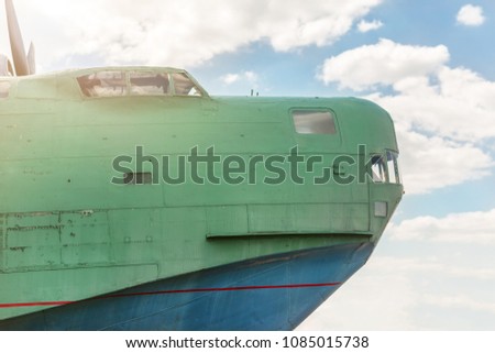 Front part of old amhibian plane against blue sky. Vintage anti-submarine military hydroplane aircraft . Toned