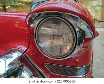 Front Part Of A Red Classic Car Of The 60s With A Round Headlights. Fancy Vintage Retro Car Attracting The Attention Of Visitors And Amateurs Of Antiquity