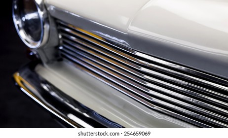 front part of a vintage car (an old Opel Kadett, logos removed), shallow depth of field
