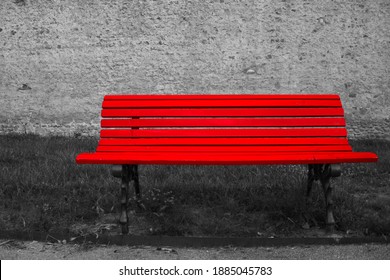 Front Photo Of A Red Bench Positioned Inside A Public Garden, Highlighted In A Black And White Context.
