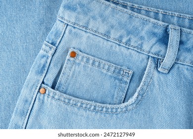 Front pocket and small pocket blue jeans pants close up, macro. Fashion concept, business, shopping, sale. Design detail, button and seams, copy space - Powered by Shutterstock