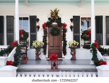 Front Porch Of A Key West Style Home In Florida Decorated In Holiday Wreaths And Bows For Christmas