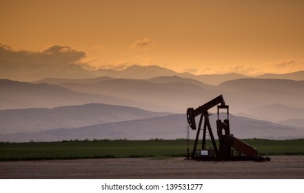 Front Range Pumpjack with Crepuscular Rays and Dramatic Clouds