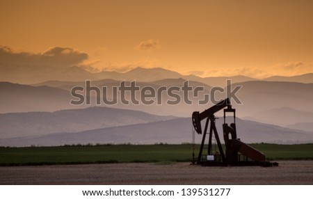 Front Range Pumpjack with Crepuscular Rays and Dramatic Clouds