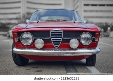 The front of a red  classic Italian car  - Powered by Shutterstock