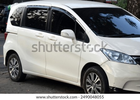 Front right perspective selective focus shot of a white MPV
