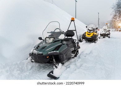 Front Scene View Many Modern Snow Mobile Scooter Atv Vehicle Forest Road Against Woods On Cold Snowy Winter Day. Snowmobile Rental Sport Adventure Trip Service. Arctic Nordic Snow Sledge Transport