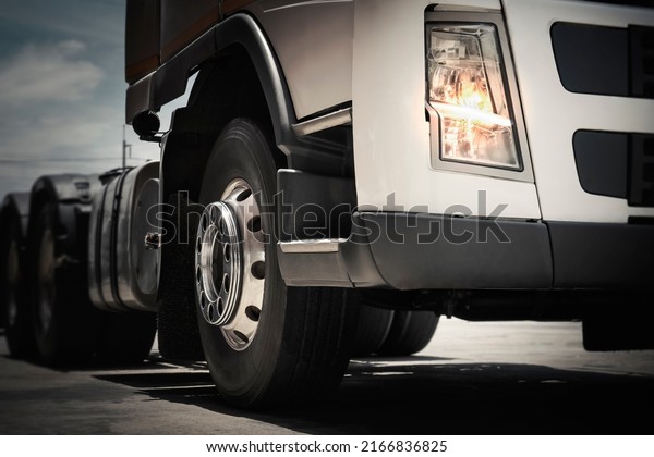 Front of Semi Truck is\
Parked. Truck Wheels Tires. Tractor Lorry. Freight Trucks Cargo\
Transport Logistics