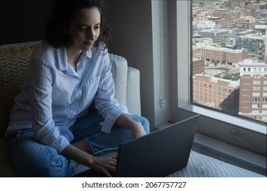 Front Shot Of Smiling Latina Woman Working On Laptop From Home, With Copy Space.