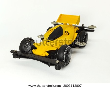 Front Side Isometric View of Custom Yellow Black Carbon Mini 4WD Racing Car with Scale 1:32, Isolated on White Background