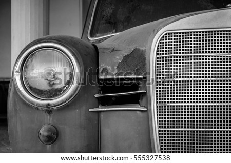 The front side of an old car. Giving emphasis to metal parts.No matter its age,luxury and magnificence still dominate.