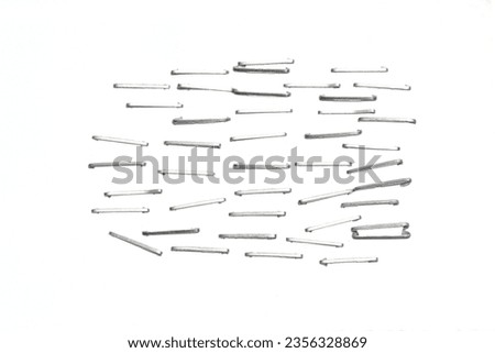 Front side staples pushed into a piece of white paper. Isolated on white background. [[stock_photo]] © 