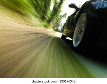 Front Side View Of Black Car Driving Fast.