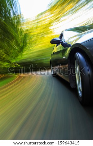 Front side view of black car with heavy blurred motion.