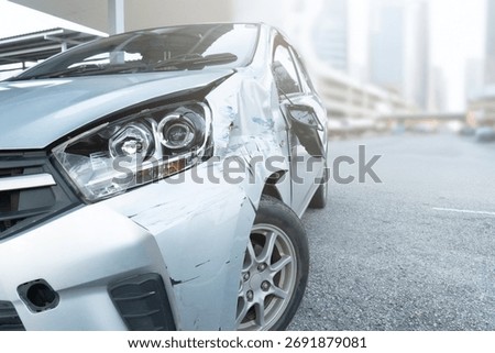 Front side view of a car with visible damage and dents after an accident. Vehicle crash, insurance claim, road safety, and car repair concept.
