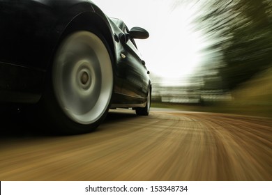 Front Side View Of Speeding Car.