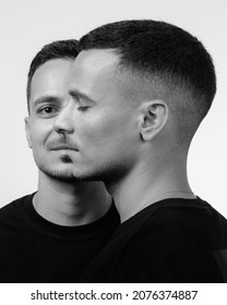 Front And Side View Of Young Handsome Twin Brothers Standing Isolated Over White Background. Happy People Posing In Studio, Family Relationship. Black And White Photography.