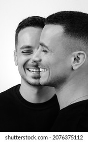 Front And Side View Of Young Handsome Twin Brothers Smiling, Standing Isolated Over White Background. Happy People Posing In Studio, Family Relationship. Black And White Photography.