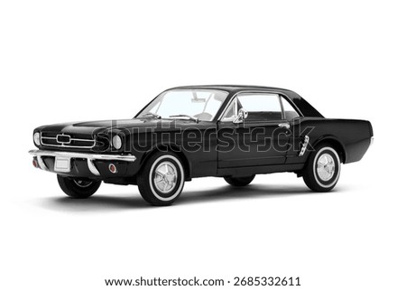 Front and slight left side view of a black muscle model toy car on a white background, showcasing its iconic grille and sleek side profile