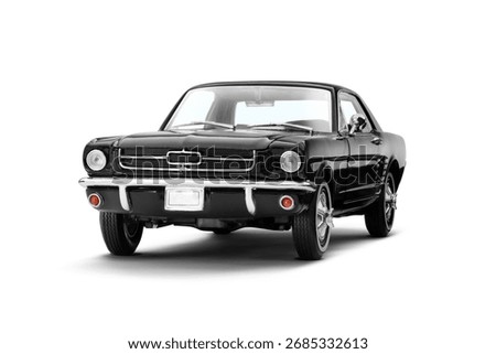 Front and slight left side view of a black muscle model toy car on a white background, showcasing its iconic grille and sleek side profile