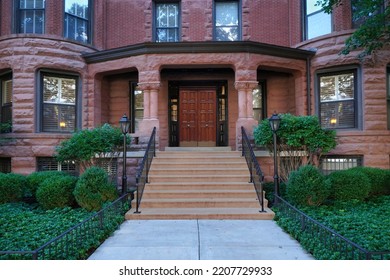 Front Steps Of Old Brownstone Style Apartment Building With Large Porch