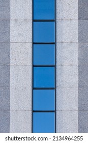 A Front Texture View Of A Building With A Straight Row Of Tiles Of Glass And Vertical Stripes Of Beige And Dark Tiles. Vertical Bright Shot