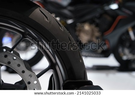 The front tire of a parked motorcycle car show motorcycle parts