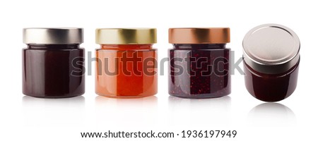 front and top view of set of small jam jars in different colors without labels and shiny metallic lid covers isolated on white background