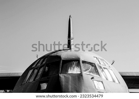 Front of US Air Force military C-130 hercules cargo plane in greyscale up close
