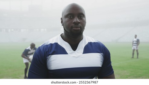 Front view of African american male rugby player standing in stadium. He is looking at camera 4k - Powered by Shutterstock