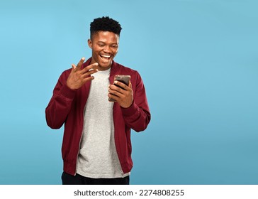 Front view of an African American man on a video call with his friends over a blue Background - Powered by Shutterstock