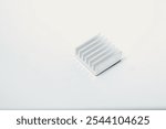 Front view of an aluminum heat sink on a white background. A component part of an electronics or computer work.