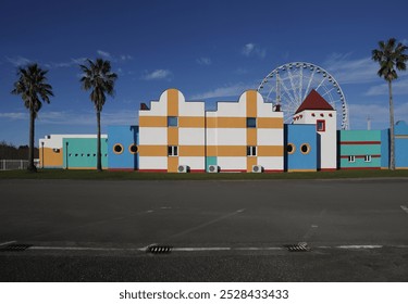 front view of amusement park with Ferris wheel and roller coaster at sunset in Georgia at Tsitsinatela Park. Ferris wheel with air illumination. Recreation area of Georgian park on Black Sea coast. - Powered by Shutterstock