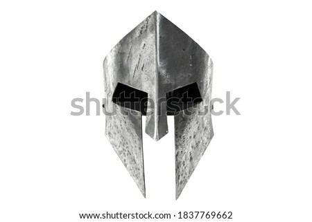 Front view of ancient iron spartan helmet isolated on white studio background. Medieval armor, archeological souvenir from past times, metal tough head protective clothes.