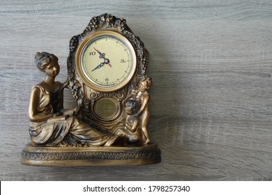       front view Antique Table Clock on brown wooden background, object, copy space                         