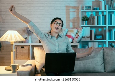 Front View Of Asian Business Woman Groaning While Spreading Her Hands Up In The Air. Korean Lady At The Halfway Stage Of Her Project Is Trying To Kick Up Energy And Stay Awake By Stretching