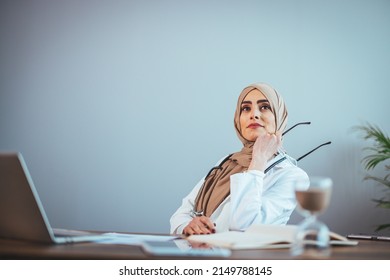 Front View Of A Beautiful Doctor, A Beautiful Muslim Woman In Uniform With A Stethoscope, Who Is Meditating In A Hospital Clinic. One Person Who Has Expertise In Professional Treatment.